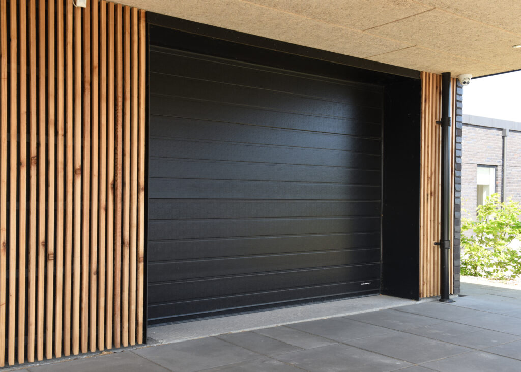 Timburhús með svartri bílskúrshurð